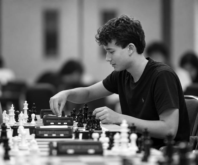 Matvey Fedorov playing chess at a tournament